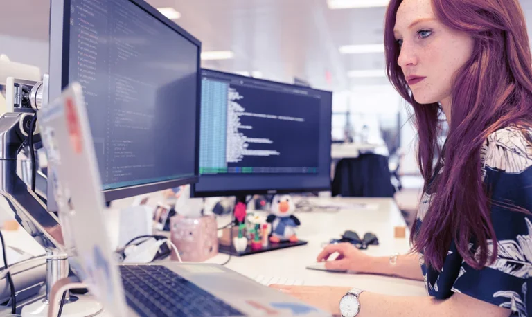 woman looking at screens